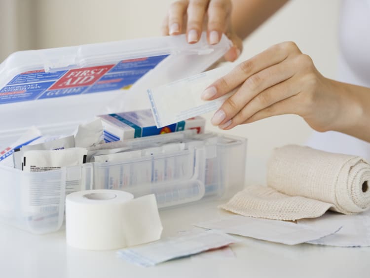 Woman stocking first aid kit