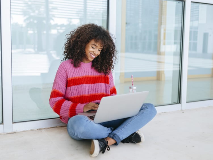 college student working on her online class outside