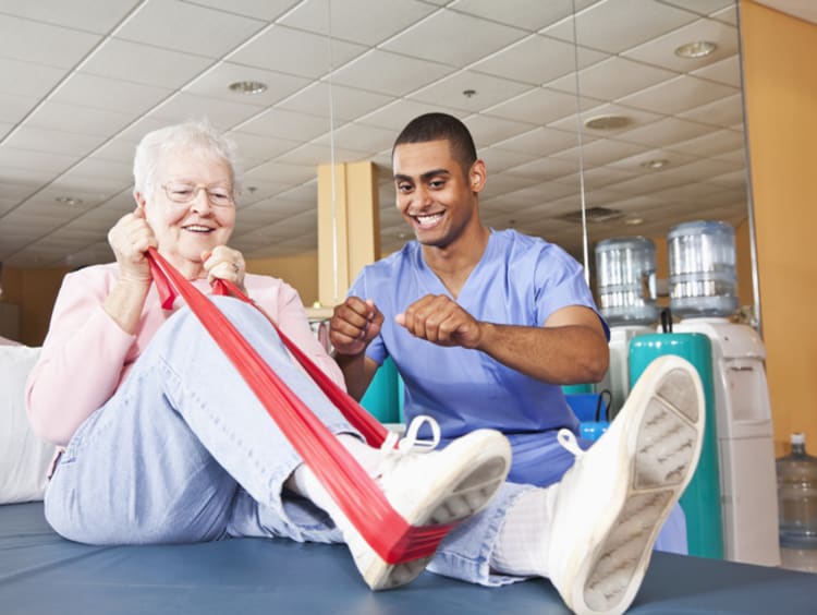 physical therapist helping a patient stretch during a session