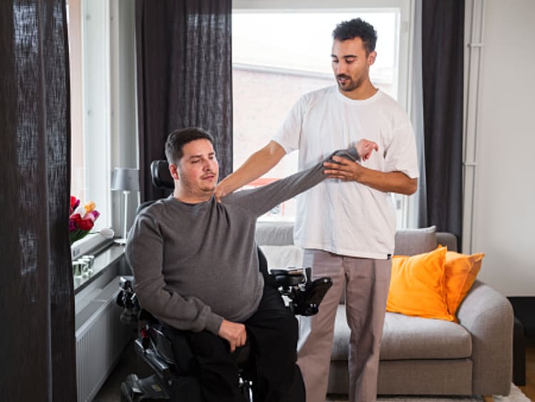 Physical therapy degree graduate helping a patient