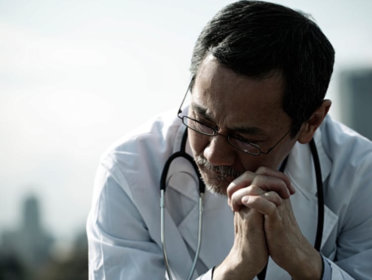 Concerned Doctor Praying