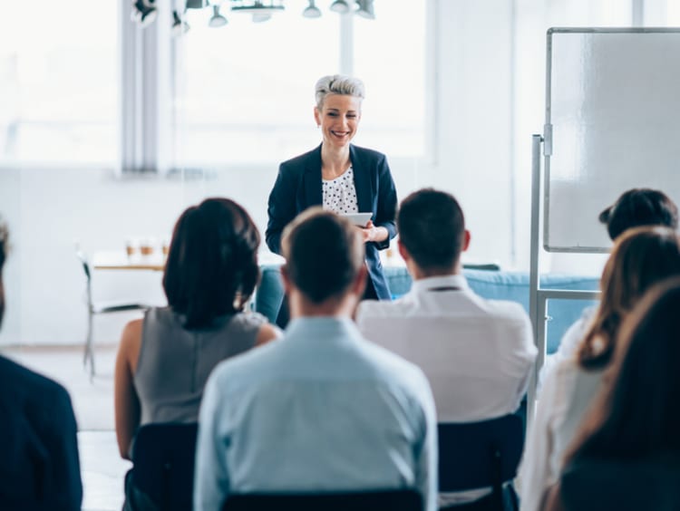 organizational leader running a meeting with their team