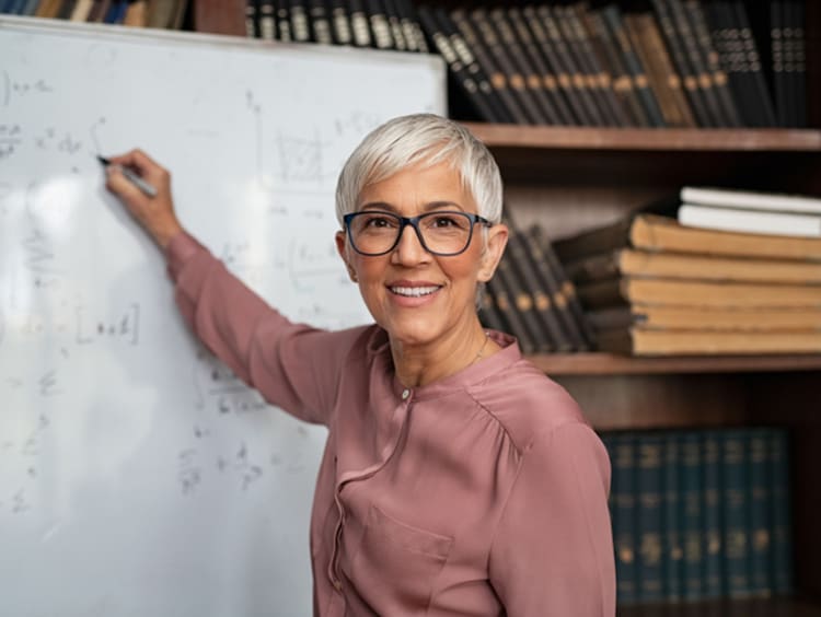 EdD degree instructor writing on whiteboard