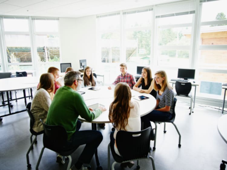 A group of students talking at a table