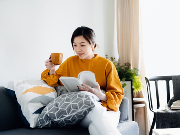 Woman reading book about the Science of Reading