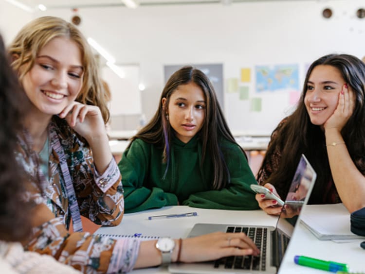 A group of students collaborating with one another