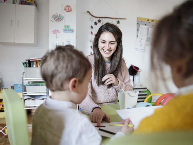 Female teacher showing children the benefits of rubrics