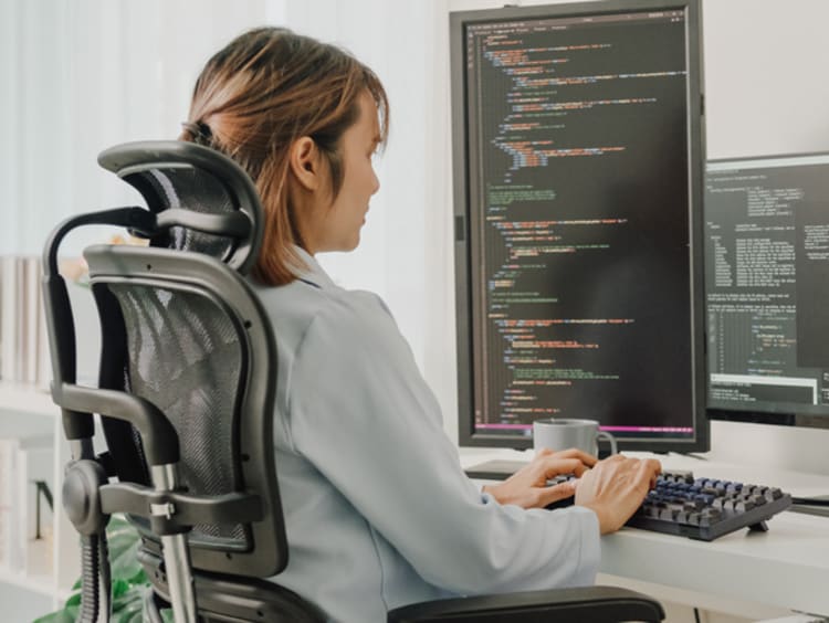 female database administrator working at her computer