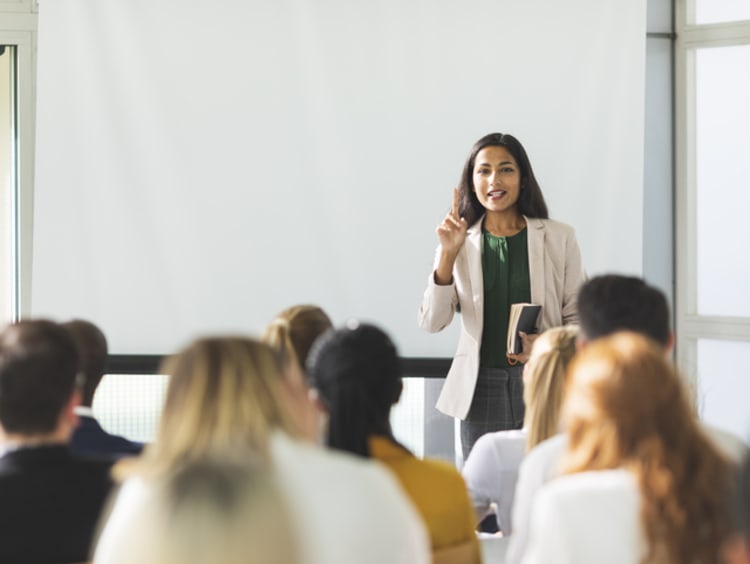 Female teaching a class of entrepreneurs