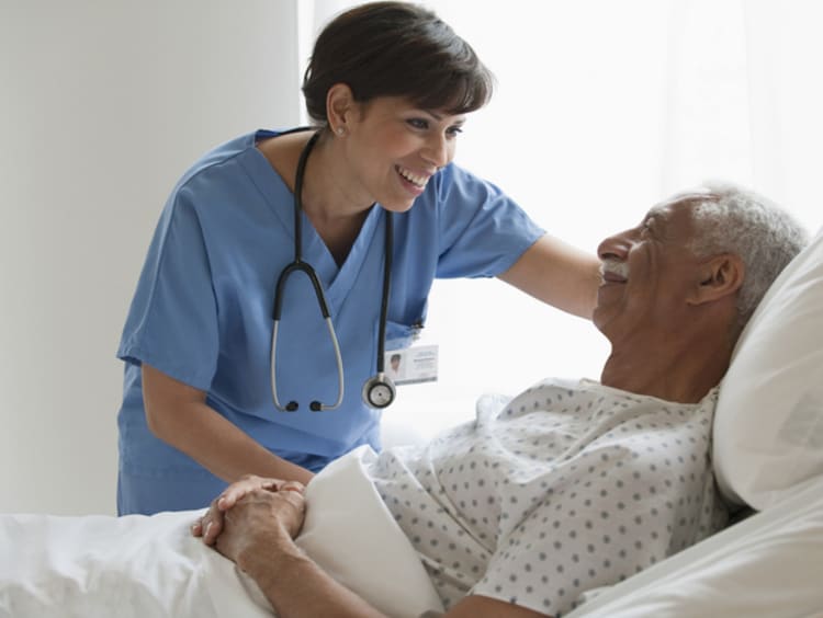 A hospitalist at bedside with patient