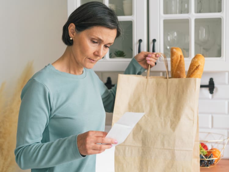 woman looking at grocery list