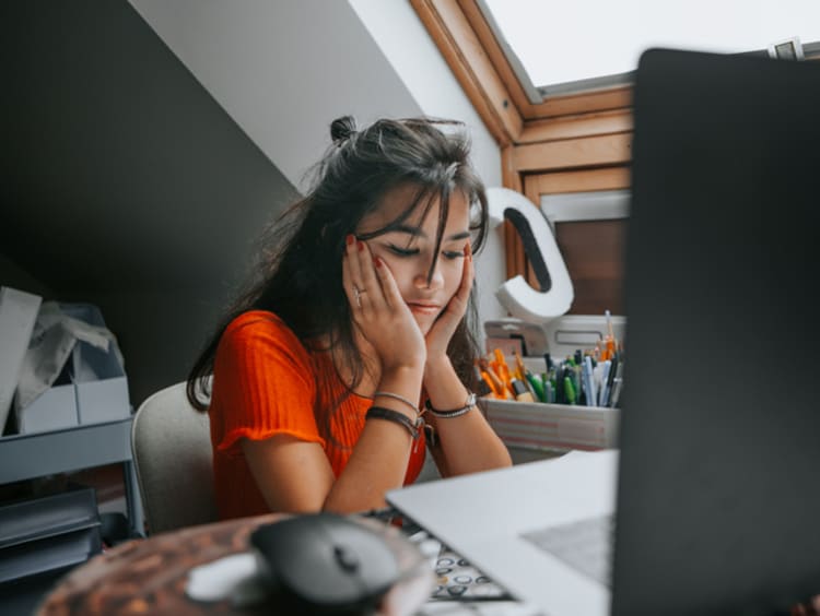 Student looking frustrated at desk