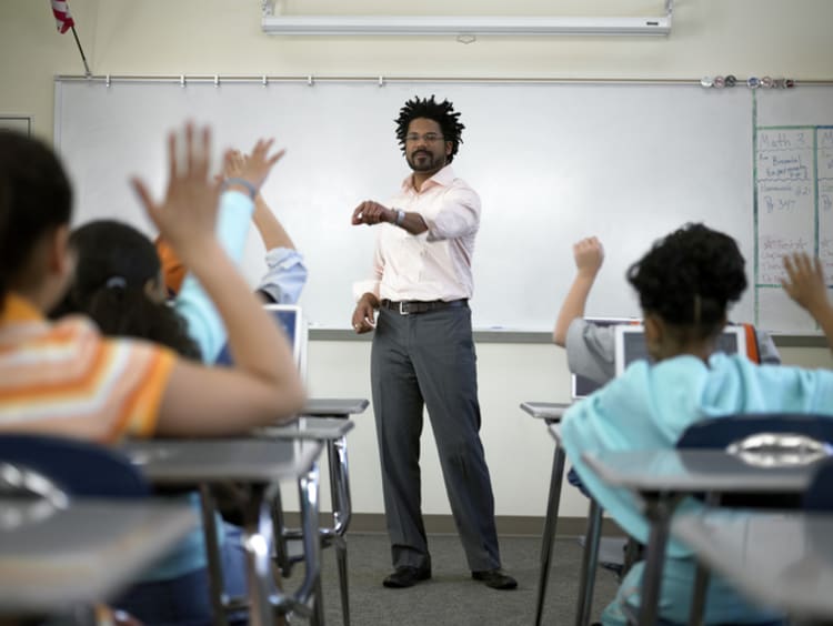 Male teacher in classroom with students