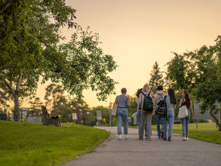 college students walking together on a sidewalk