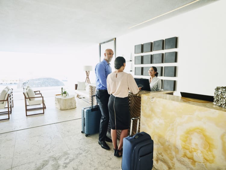 people checking into a hotel