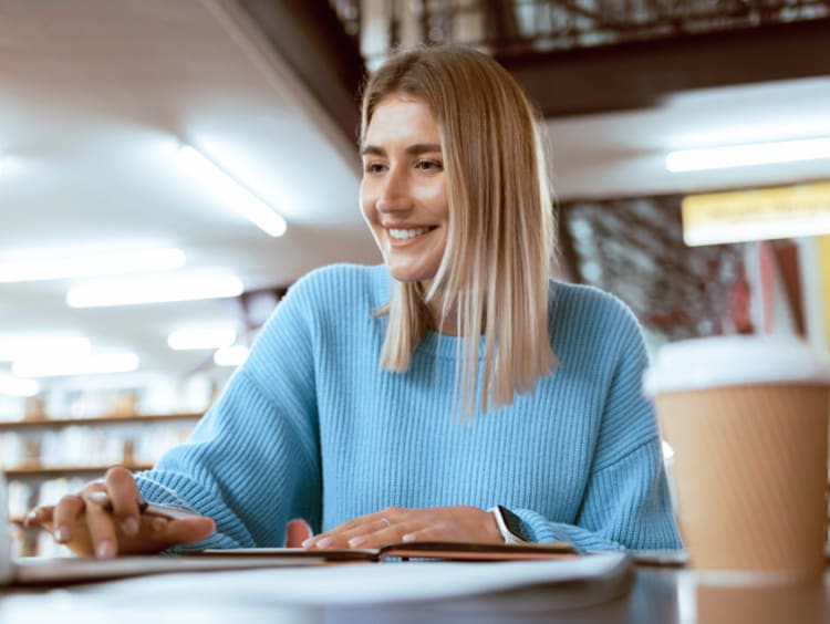 Young female phd student working on her laptop