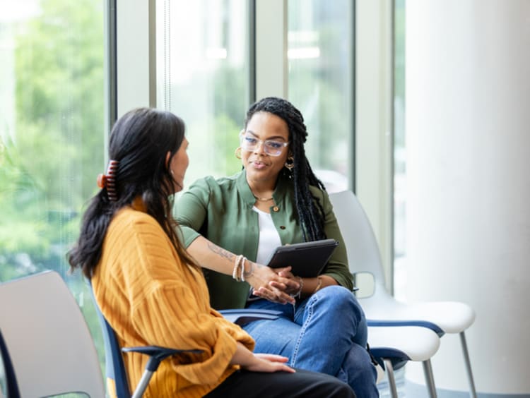 Doctoral student sitting with professor