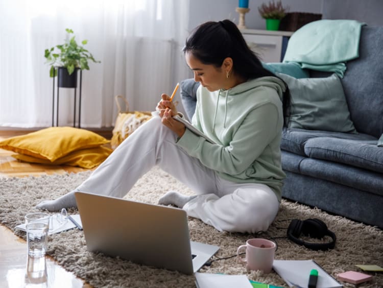 College student working on an essay in her apartment