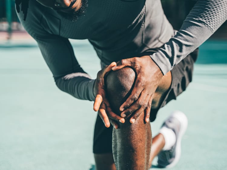 Man checking his knee for pain