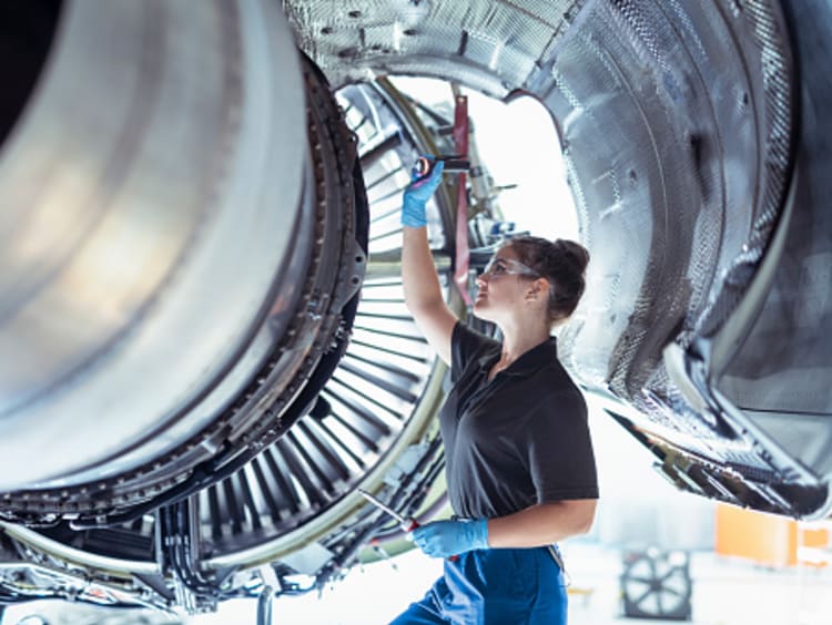 woman engineer examining an airplane wing