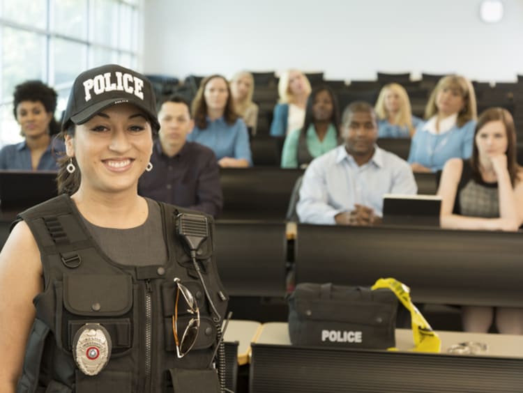 Female police officer in a classroom of students of the academy