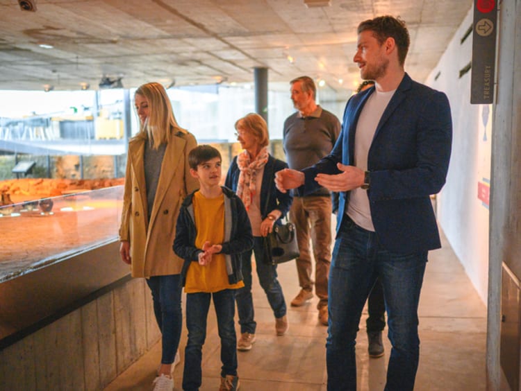 Historian giving a tour to a group of people in a museum