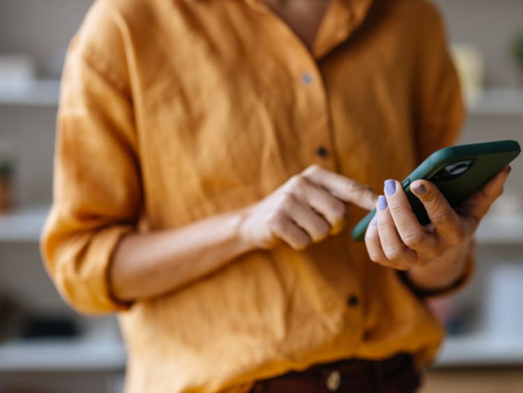 a woman using her phone indoors