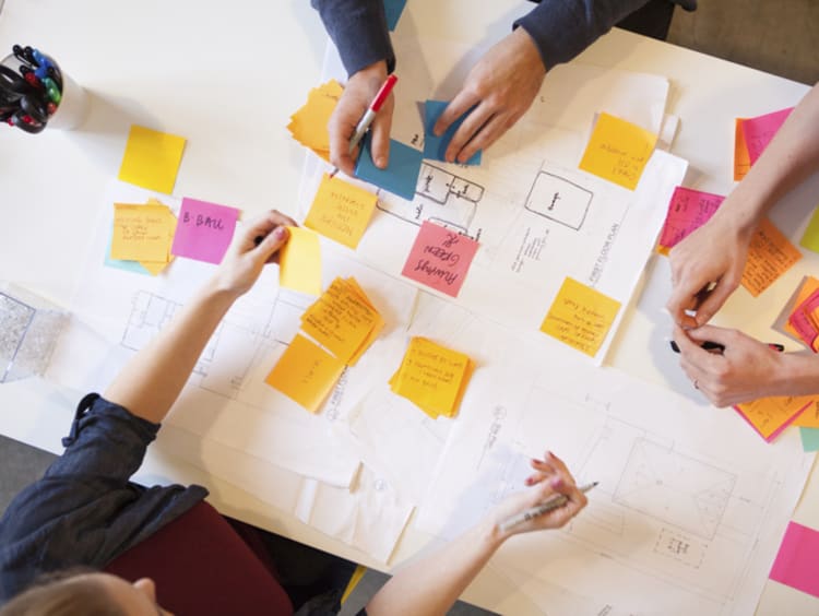 people meeting together organizing papers and information