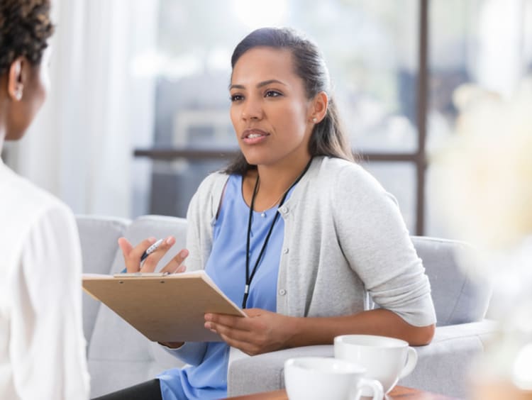 Health psychologist meeting and talking with a patient