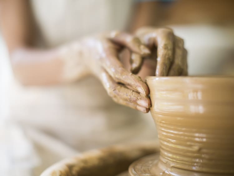 Close up of female potters hands making bowl - stock photo