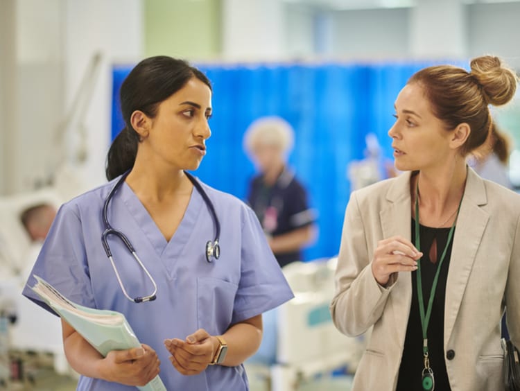 Two colleagues discuss hospital affairs.