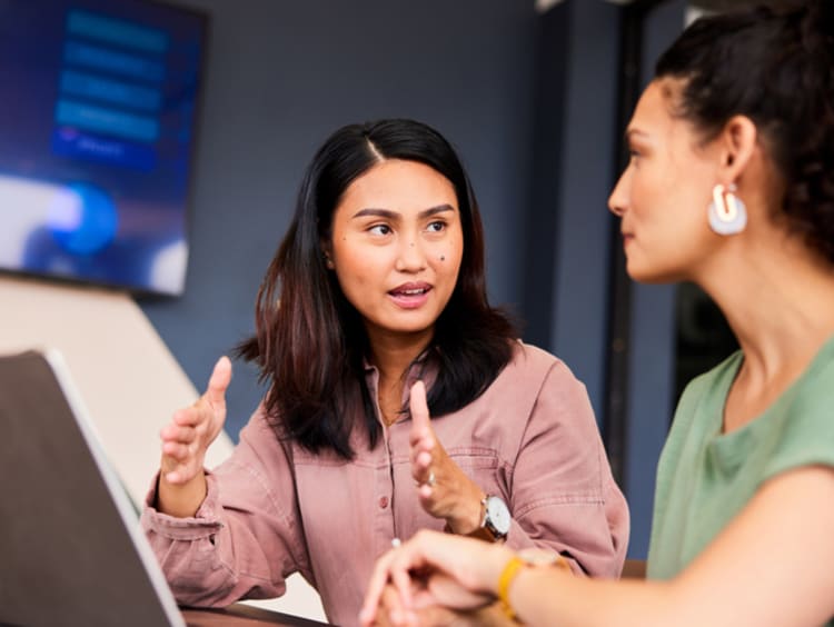 Woman speaking with her colleague.