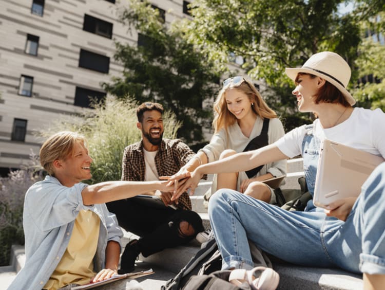 Group of students working ethically together on college campus.