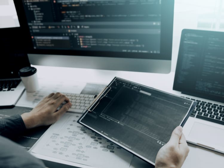 computer and iPad with coding