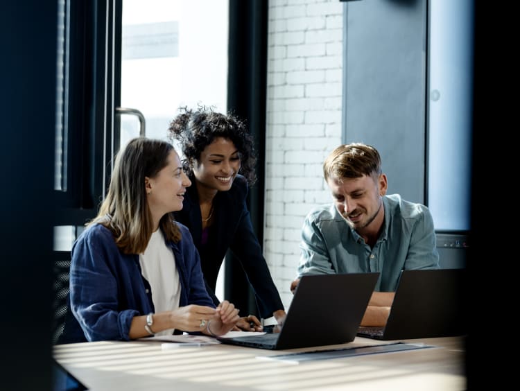 people surrounding computer at work