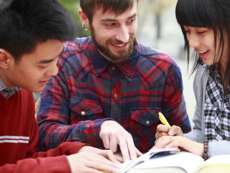 Students looking at a book