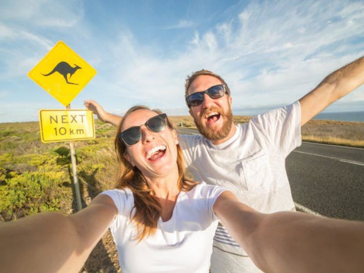 Kaitlyn posing in front of a sign in Australia