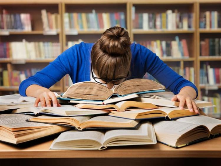 person with head in books