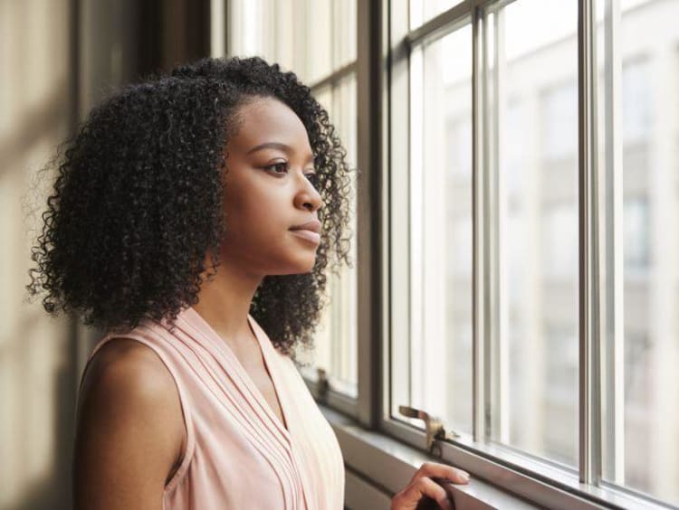 woman looking out a window