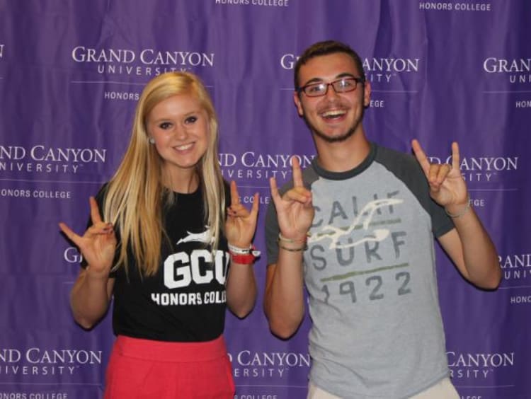 two students holding a lopes up