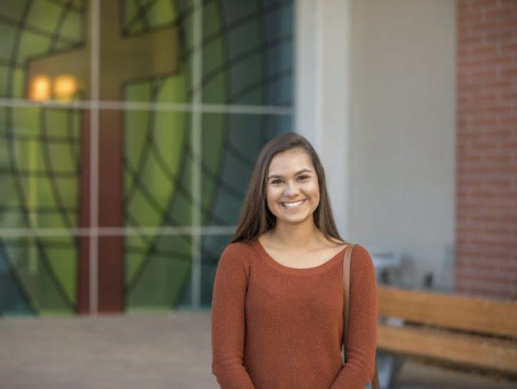 Tatum in front of the College of Theology