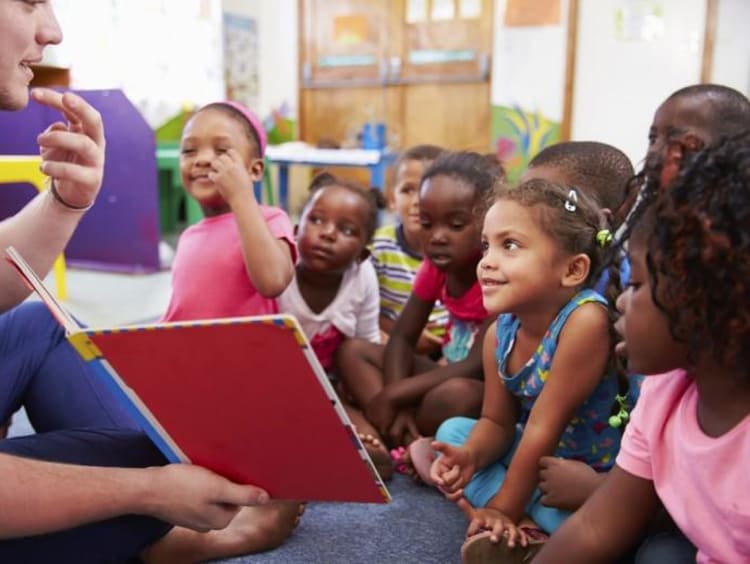 Man reads and signs to kids during storytime