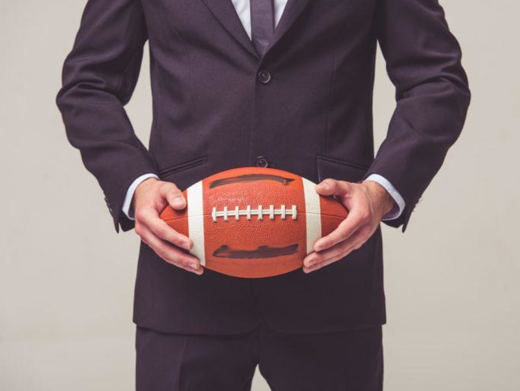 Businessman holds a football