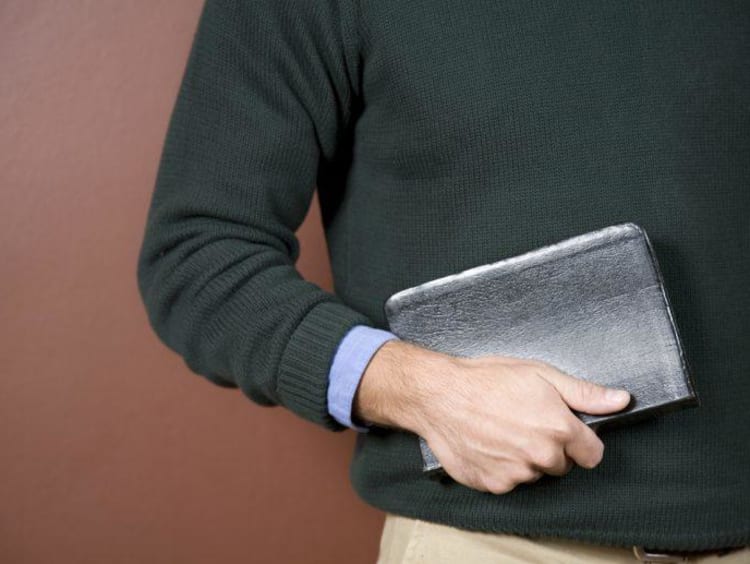 A student holding the Bible 