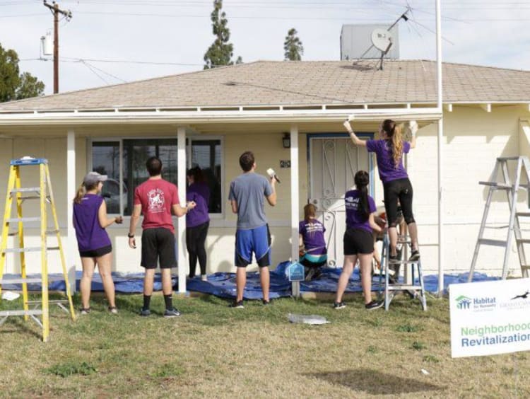 A group of volunteers working on a house