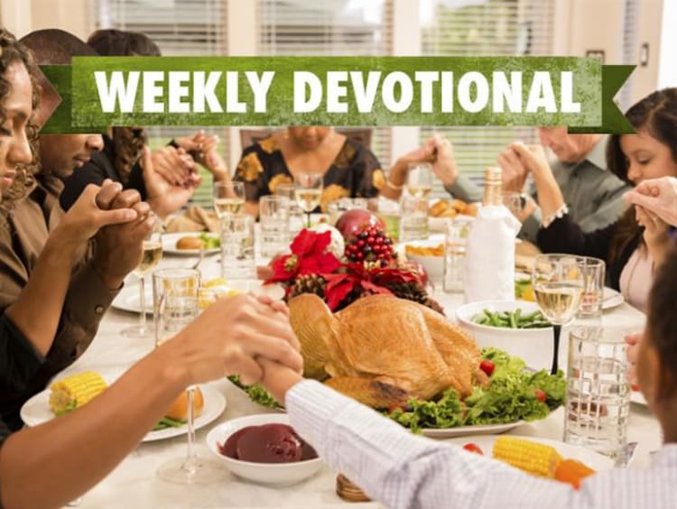 A Thanksgiving table with the Weekly Devotional banner