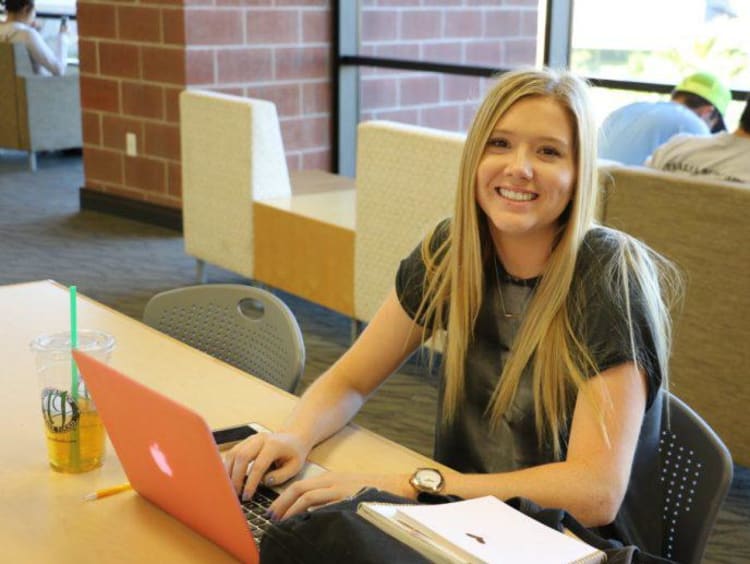 A student studying in the GCU library