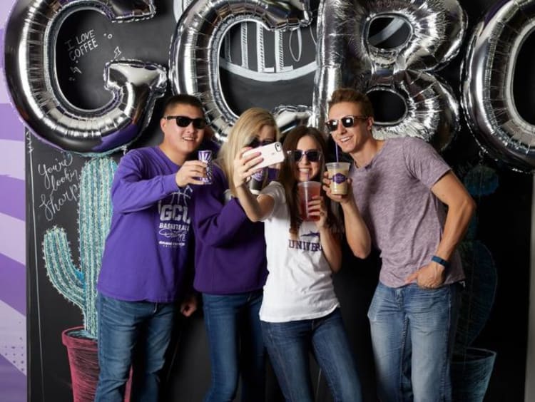 students holding coffee