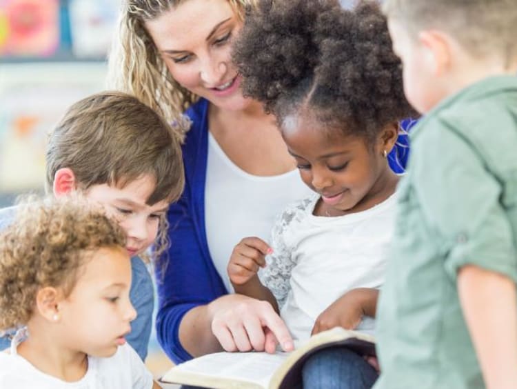 teacher helping children learn