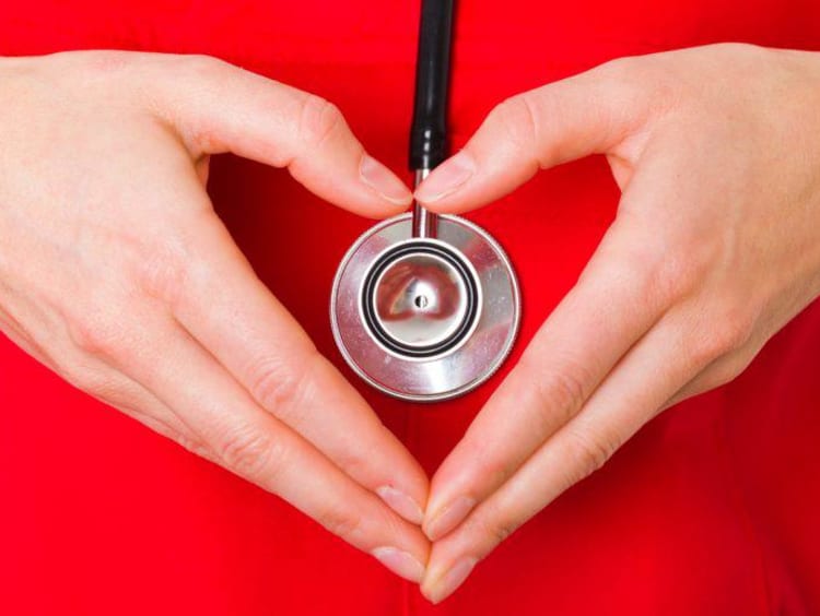 stethoscope with heart hands around it 